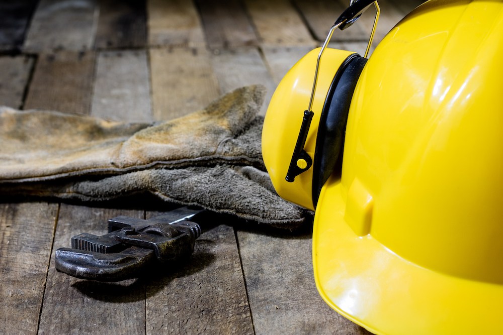 construction equipment on a table with professional hearing protection