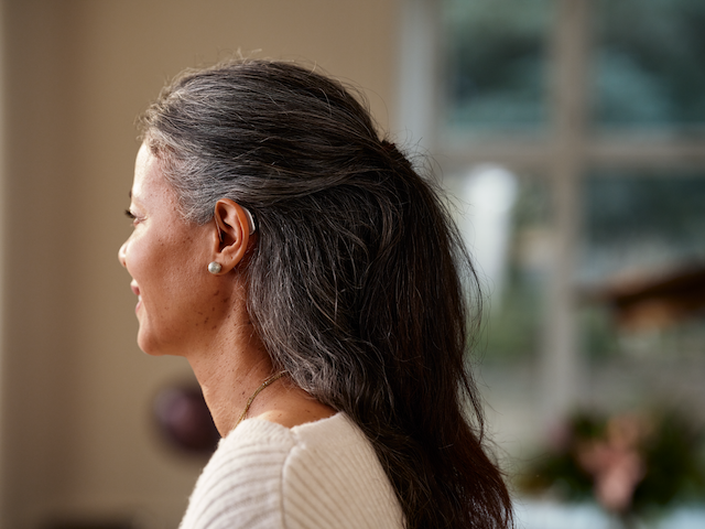 Showing the Widex Allure™ on a female's ear